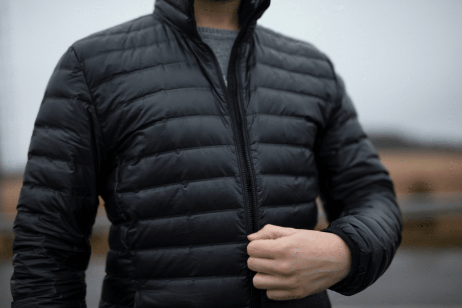 man zipping a puffy winter coat